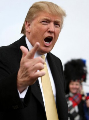 Donald Trump gestures whilst standing on the sand dunes on Menie Estate, the site of his new golf course.