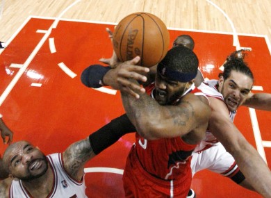 Atlanta Hawks forward Josh Smith, center, battles Chicago Bulls' Carlos Boozer, left, and Joakim Noah for a rebound during the first quarter last night.