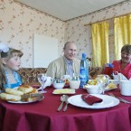 Russian Prime Minister Vladimir Putin visits the home of Dasha Varfolomeyeva, left. Two years ago Dasha asked Putin for a fairy tale dress on television. (AP Photo/RIA Novosti, Alexei Druzhinin)