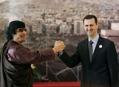 File photo of Libya's Gaddafi meeting Syria's Assad in 2008. Turkey has warned Damascus that it will suffer the same fate as Tripoli if Assad does not