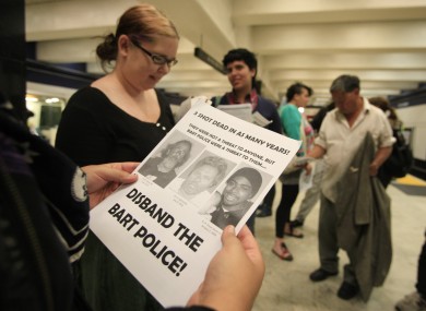 A protester reads an instruction sheet before a previous demonstration in July began at the Civic Center BART station in San Francisco