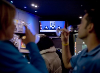 A couple drink whilst they look at Spanish TV at a bar in Pamplona northern Spain, showing members of the Basque separatist group ETA.
