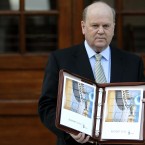 Finance Minister Michael Noonan in Government Buildings with the budget folio during the second day of the Irish Budget. Photo: Julien Behal/PA Wire