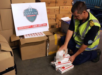 File photo of a Customs officer with seized cigarettes.