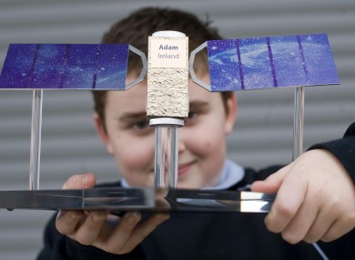 Adam Vaughan poses with a model of the Galileo satellite that will be named after him.
