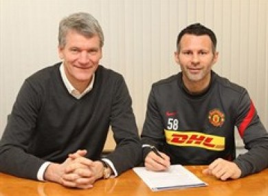 Giggs signs on with with chief executive David Gill.
