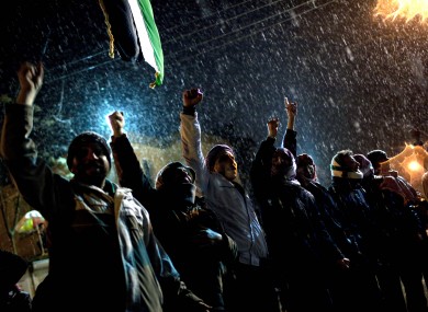 Free Syrian Army supporters chant anti-government slogans under snowfall on the outskirts of Idlib in the north of the country