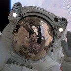 Discovery astronaut Stephen K Robinson is relfected in his colleague Soichi Noguchi's helmet during the Return to Flight mission in 2005. It was NASA's first shuttle mission following the Columbia disaster of 2003. Columbia broke apart while returning to Earth, just minutes from landing, with the loss of all seven crew. (Image: NASA)