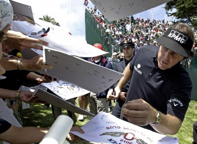 Phil Mickelson signs autographs after a practice round yesterday..