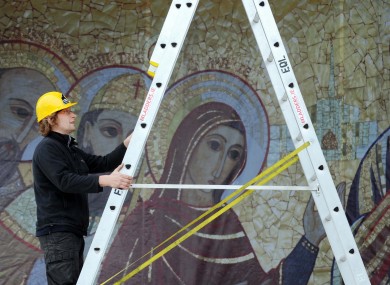 Workers put the finishing touches to the main stage at the Eucharistic Congress
