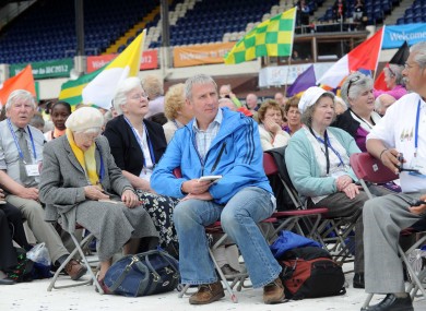 Pilgrims watch the opening address yesterday