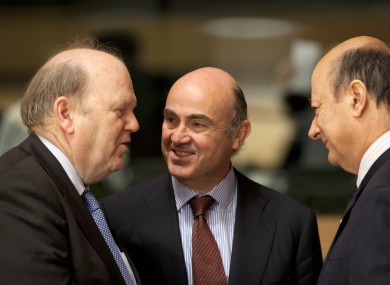 Finance Minister Michael Noonan, Spain's Economy Minister Luis de Guindos and Poland's Finance Minister Jacek Rostowski share a word during a meeting of EU finance ministers at the European Council building in Luxembourg