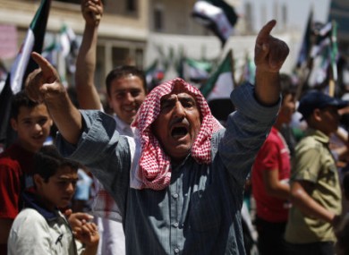 A Syrian man chants slogans during an anti-Bashar Assad protest after Friday prayers on the outskirts of Idlib.