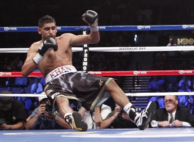 Amir Khan takes his first journey to the canvas in the third round.