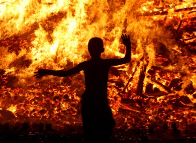 People gather at a huge bonfire on the Shankill Road in Belfast as Orange Order members celebrate the 12th of July this year