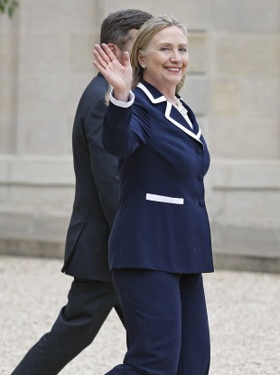 US Secretary of State Hillary Rodham Clinton waves a good bye as she leaves the Elysee Palace