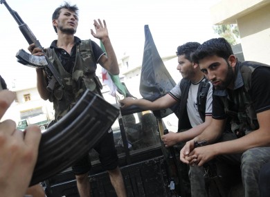 Syrian rebels sit in a pick up truck in Aleppo, Syria yesterday.