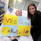 Seven-year-old Jack O'Sullivan from Tallaght, Dublin presents Katie with a special congratulations message on her Olympic success. (Photo: Mark Stedman/Photocall Ireland)
