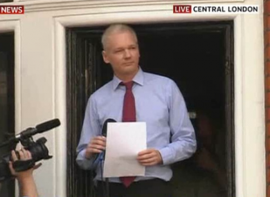 Julian Assange acknowledges supporters before speaking from a balcony at the Ecuadorian embassy in London.