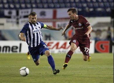 Atromitos' Ioannis Skordas goes for the ball next to Newcastle United's Romain Amalfitano.