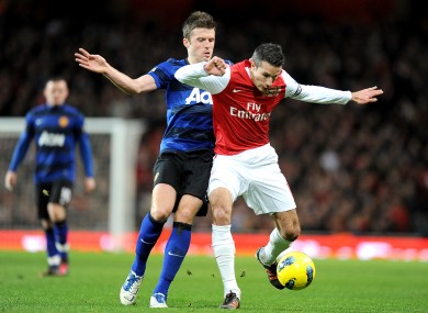 Arsenal's Robin van Persie (right) and Manchester United's Michael Carrick (left) battle for the ball.