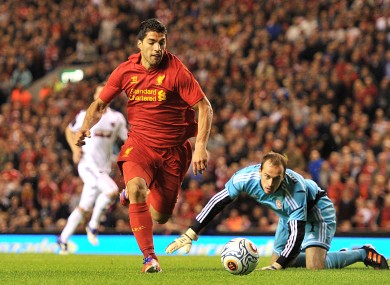Liverpool's Luis Suarez goes around Heart Of Midlothian goalkeeper Jamie MacDonald (floor) but fails to score.