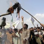 Afghans burn an effigy of US President Barack Obama during a protest in Khost, south-east of Kabul, Afghanistan today. A few hundred university students protested against an anti-Islam film which depicts the Prophet Muhammad as a fraud, a womanizer and a madman. (AP Photo/Nashanuddin Khan)