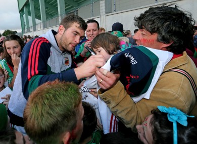 Aidan O'Shea signs autographs for Mayo fans.