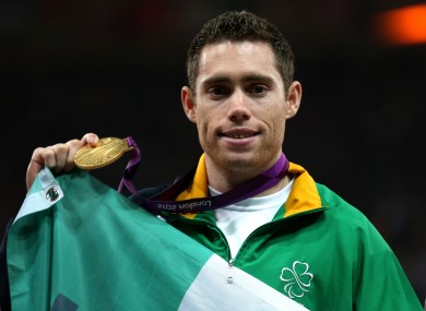 Ireland's Jason Smyth celebrates with his Gold medal on the podium after winning the Men's 200m T13 Final at the Olympic Stadium