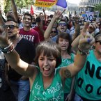 People protest against austerity measures applied by the Spanish government, in Columbus Square in Madrid, Spain, Saturday, Sept. 15, 2012. Tens of thousands of people from all over the country converged on Madrid to hold a large anti-austerity demonstration on Saturday. By mid-morning several major roads had been blocked as buses unloaded protesters at 10 rendezvous points from which marches began.The demonstration was called to protest government cuts during the country's financial crisis. (AP Photo/Andres Kudacki)