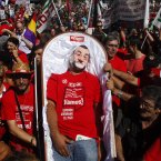 A man dressed as Spanish Prime Minister's Mariano Rajoy plays dead during a protest against austerity measures. (AP Photo/Andres Kudacki)
