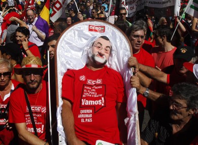 A man wearing a Mariano Rajoy mask plays dead during an anti-prosperity protest in Madrid.
