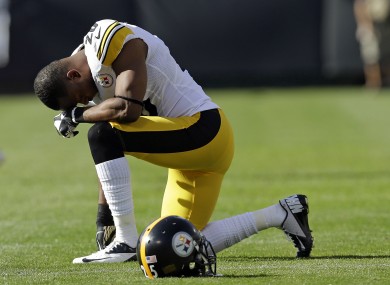 Pittsburgh Steelers safety Ryan Clark kneels and waits following the injury to Oakland Raiders' Darrius Heyward-Bey.