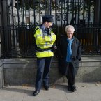 Author and broadcaster Nell McCafferty speaks to a Garda at the rally outside Leinster House.