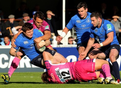 Leinster's Brian O'Driscoll tackled by Jason Shoemark and Phil Dollman of Exeter.