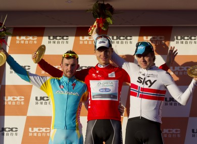 Tour winner Tony Martin of Germany, center, second place Francesco Gavazzi of Italy, left, and third place Edvald Boasson Hagen of Norway, right, celebrate during an award ceremony for the 2012 Tour of Beijing.