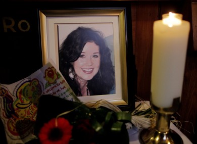 A candle burns during a Memorial Mass for murdered Irish woman Jill Meagher (seen in framed photo) at St Peter's Church, Drogheda, Co Louth