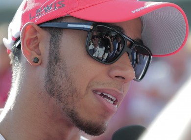 McLaren driver Lewis Hamilton of Britain talks to reporters in the F1 paddock at the Suzuka Circuit venue.