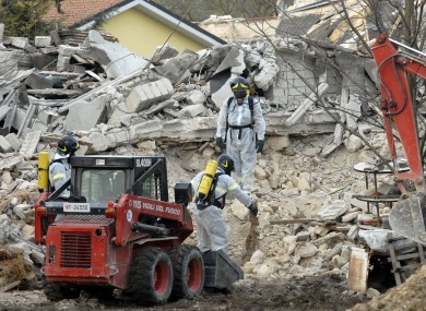 Italian firefighters work on a collapsed stable to remove dead animals from a collapsed stable in L'Aquila, where an earthquake in 2009 killed 309 people.