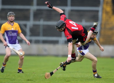 Oulart-The-Ballagh's Peter Murphy gets a hurl broke over his leg by JIm Berry of Faythe Harriers.