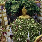Lotus flowers are thrown by worshippers on to a Buddha statue during the Lotus Flower Receiving Festival in Bang Phli district, Samut Prakarn province, east of Bangkok, Thailand. The annual festival was held to celebrate the finish of Buddhist Lent and the end the rainy season. (AP Photo/Apichart Weerawong)