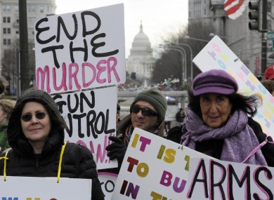 Gun control advocates protest against the National Rifle Association outside of the hotel where the NRA was having a news conference in Washington today.