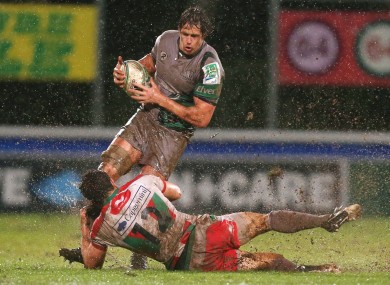 Mike McCarthy is tackled by Damien Traille.