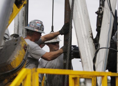 File photo of workers in the US working on a drilling platform that uses the process of fracking.