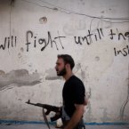 10 September: A Free Syrian Army fighter walks through a street in Amariya district in Aleppo. (AP Photo/ Manu Brabo, FIle)
