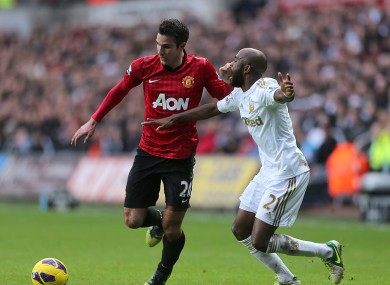 Swansea City's Dwight Tiendalli (right) and Manchester United's Robin van Persie (left) battle for the ball.