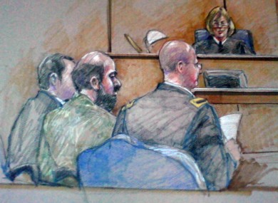 In this courtroom sketch, Nidal Hasan is seen sitting between members of his defence team during a hearing in Fort Hood