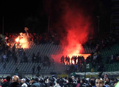 Egyptian fans rush onto the field during the deadly riot last February.