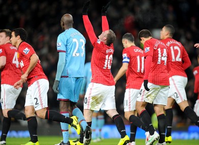Manchester United's Wayne Rooney (centre) celebrates scoring his team's first goal.