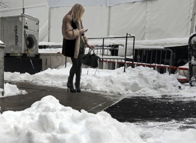 A woman checks her mobile phone outside Lincoln Center, home of New York's Fashion Week shows on Saturday.